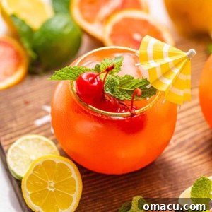 A single Bahama Mama cocktail in a tall glass, garnished with a tiny umbrella and bright maraschino cherries, evoking a tropical paradise.