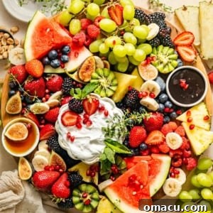 A vibrant selection of fruits arranged on a fruit platter with various dips, showcasing a fresh and appealing presentation.