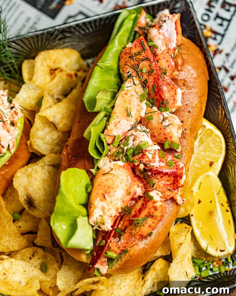 A beautifully assembled New England lobster roll resting on a serving tray, accompanied by crispy potato chips and fresh lemon wedges, ready to be devoured.