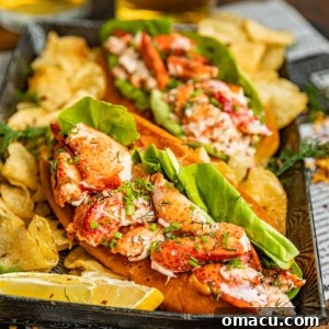 New England Lobster Rolls on a silver plate with potato chips and soda.