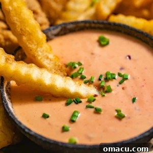 French fries dipped in creamy Boom Boom Sauce, a perfect snack.
