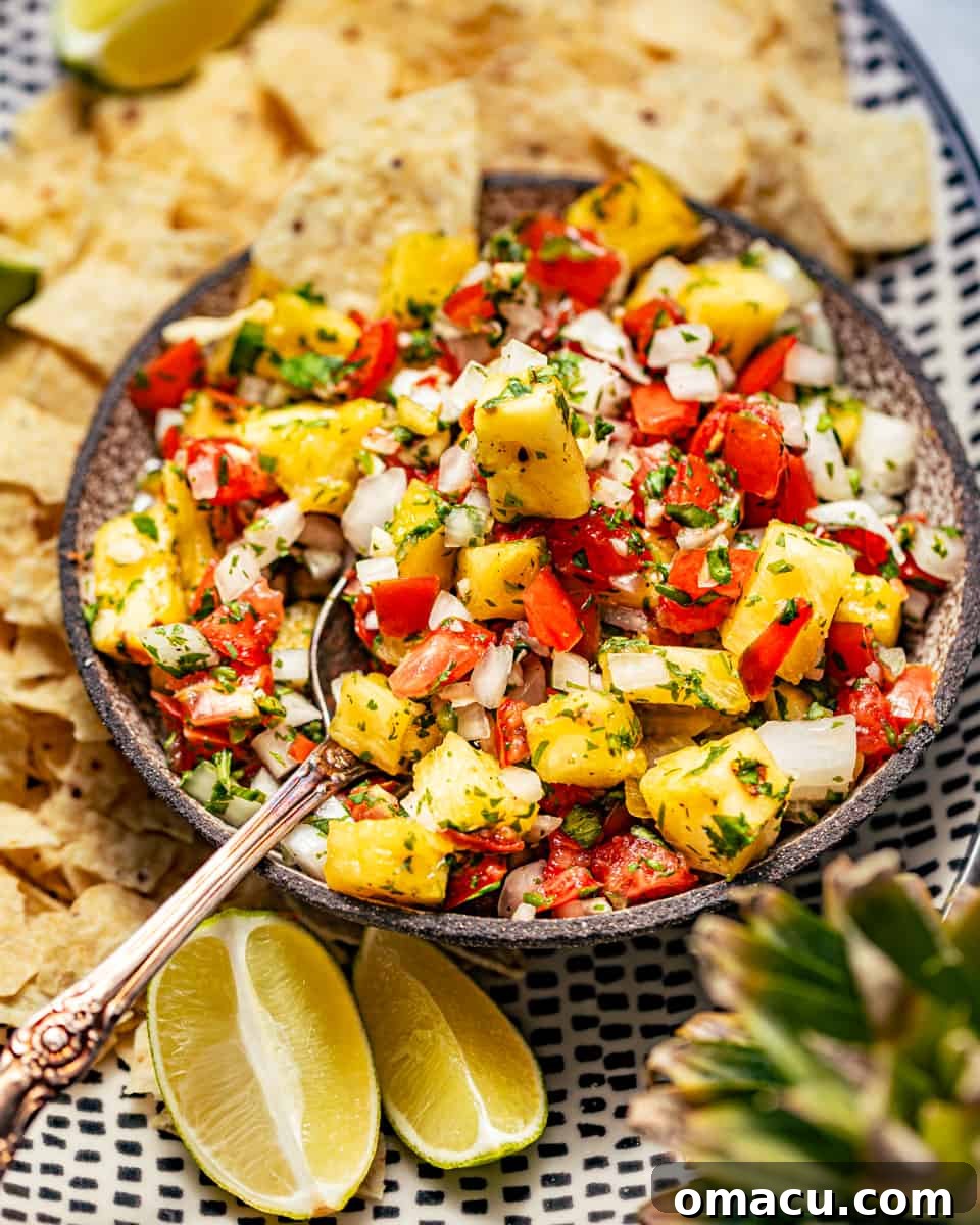 A serving dish filled with vibrant Pineapple Pico de Gallo, accompanied by crispy tortilla chips, inviting a refreshing culinary experience.