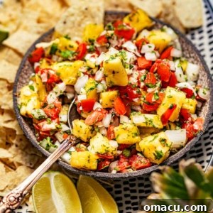 pineapple pico de gallo on a serving dish with tortilla chips.