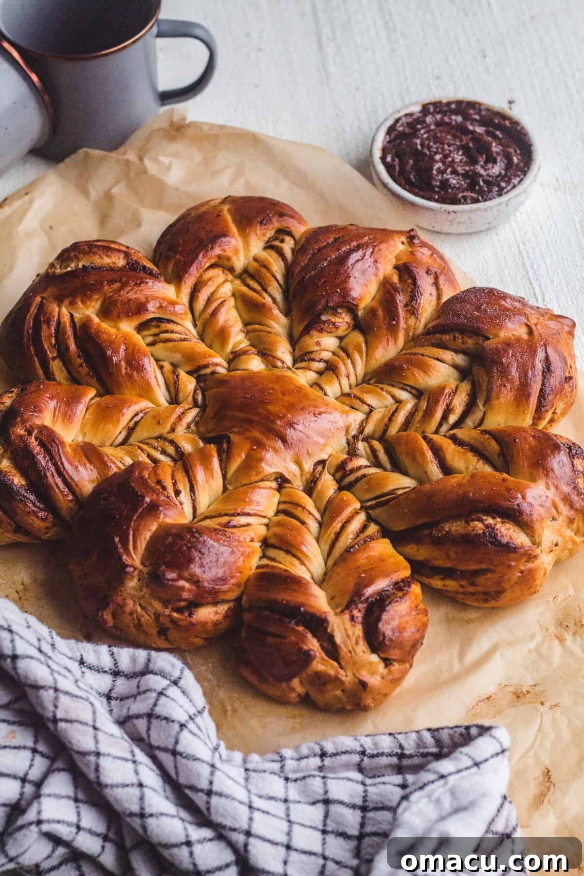 Beautifully baked prune star bread with golden crust and visible prune filling swirls.