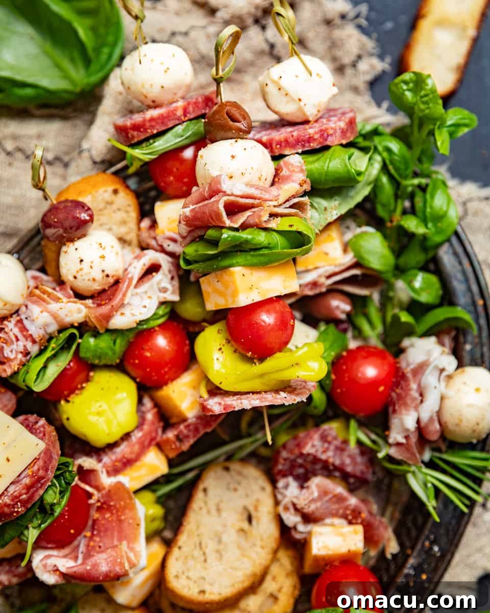 Freshly made charcuterie skewers artfully arranged on a platter, garnished with fresh herbs for an inviting presentation.