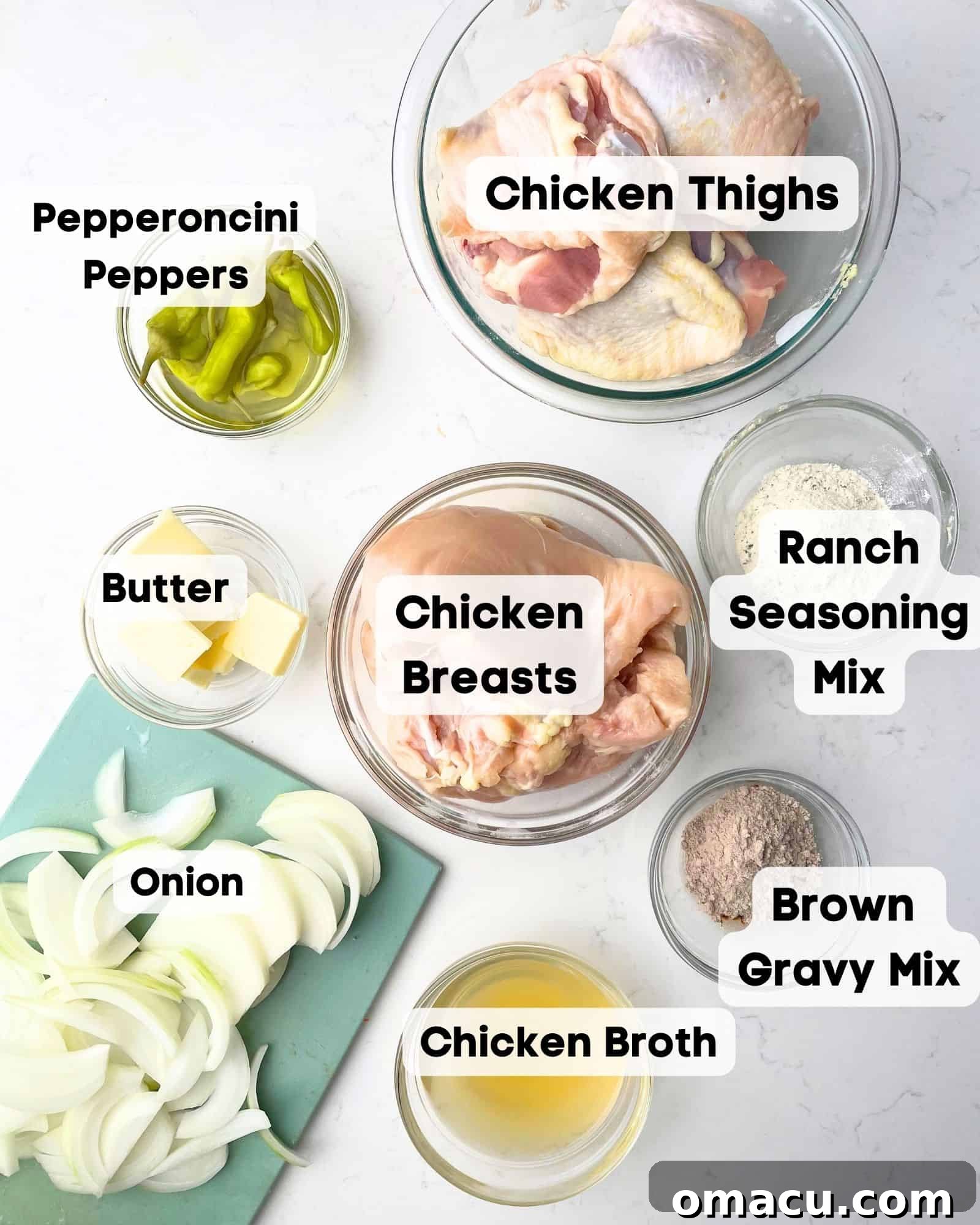 ingredients to make mississippi chicken - chicken, onions, pepperoncini peppers, pepperoncini juice, chicken broth, ranch seasoning mix, brown gravy mix, and butter.