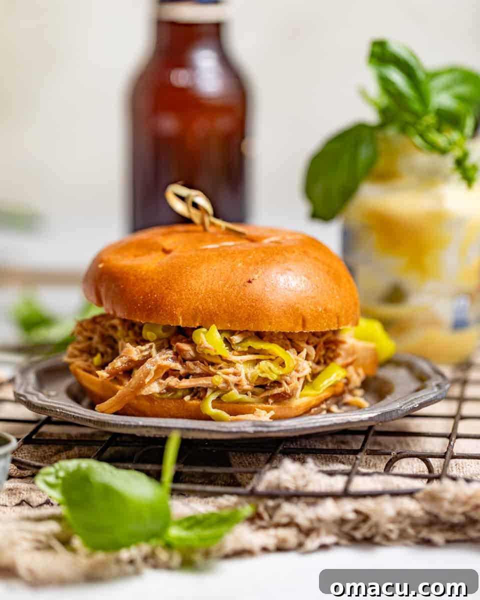mississippi chicken sandwich on a silver plate on top of a wire rack.