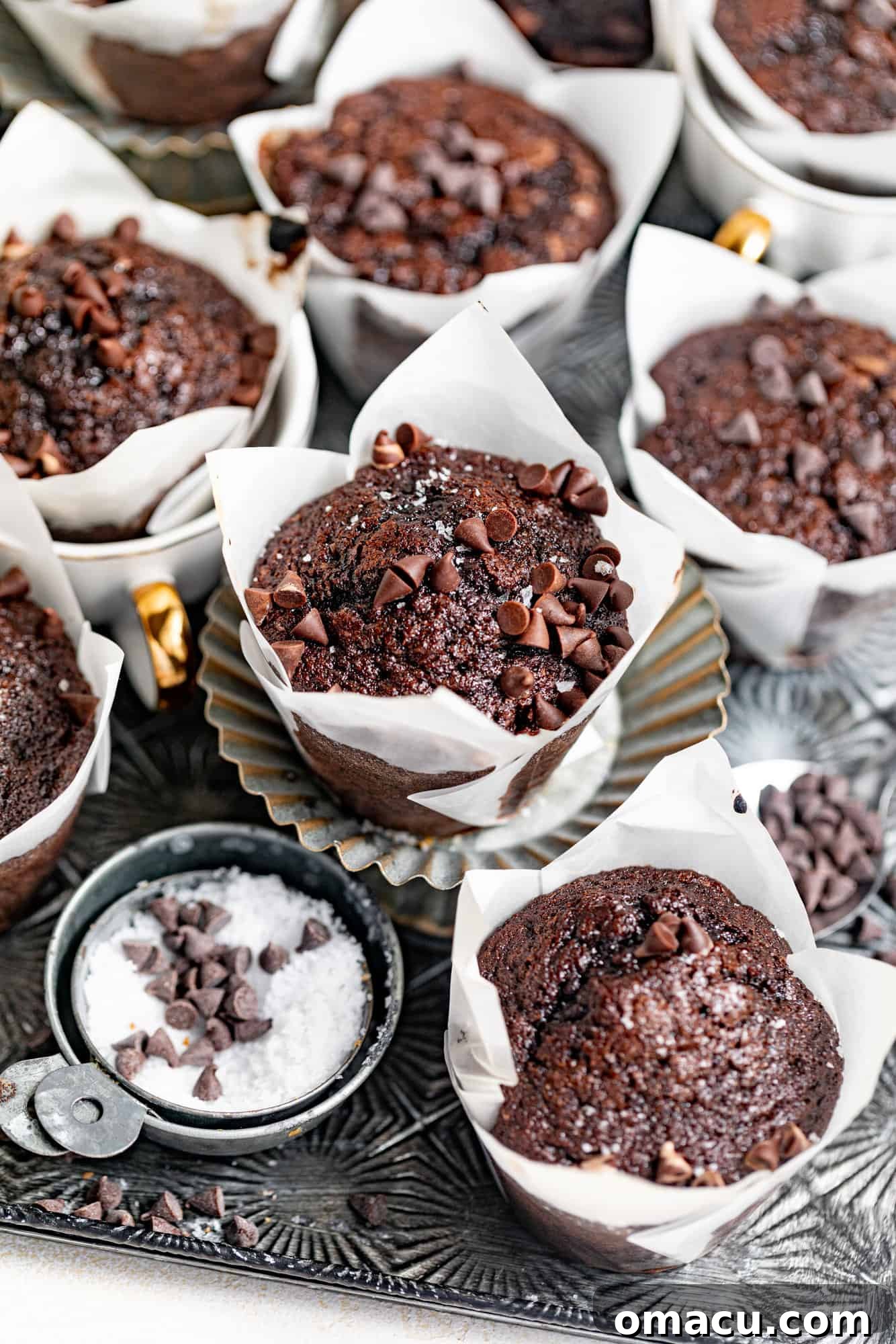 Delicious brownie muffins featuring a gooey chocolate center and chocolate chips, photographed beautifully.