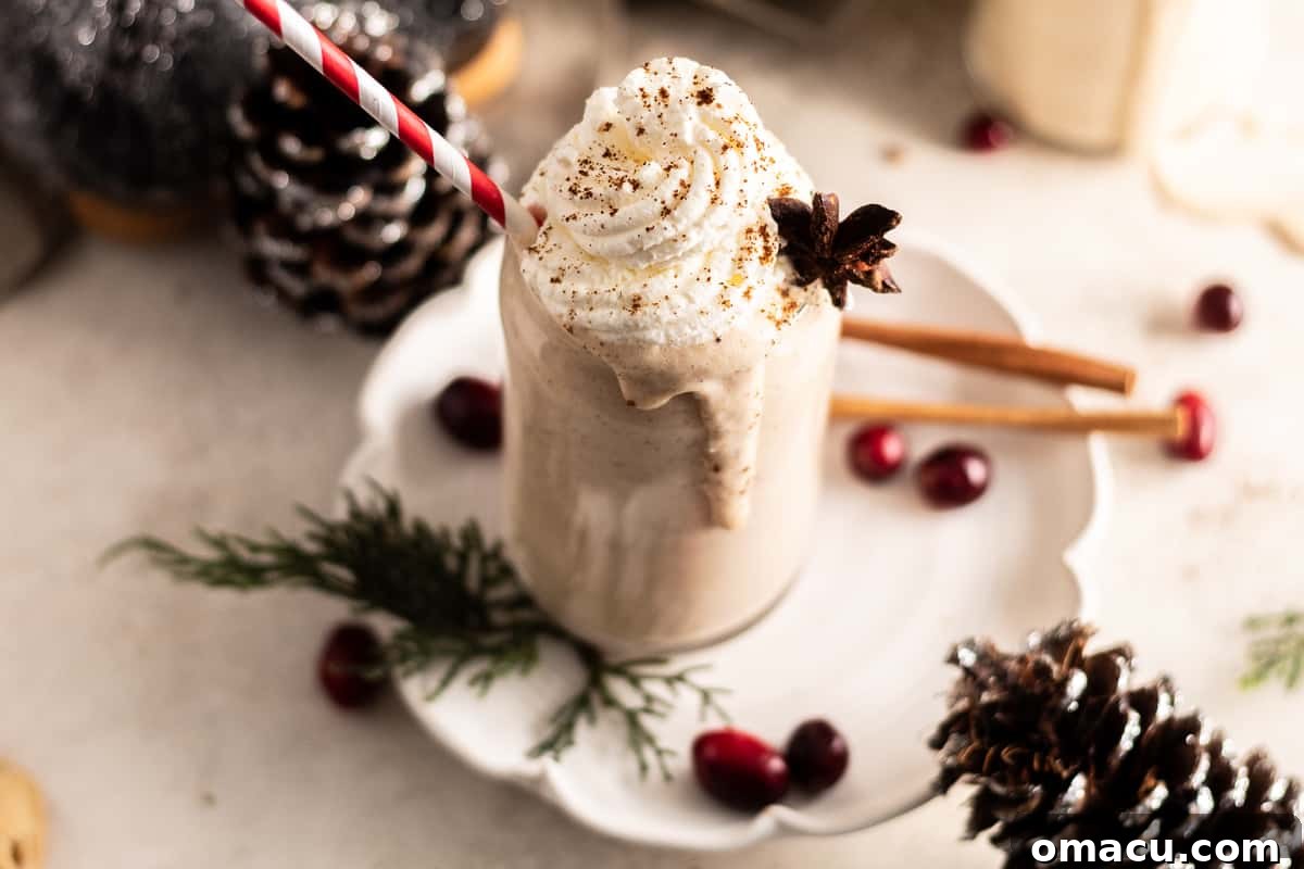 Close-up of Bourbon Eggnog in a glass with cinnamon sticks