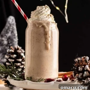 A glass of homemade Bourbon Eggnog with a cinnamon stick