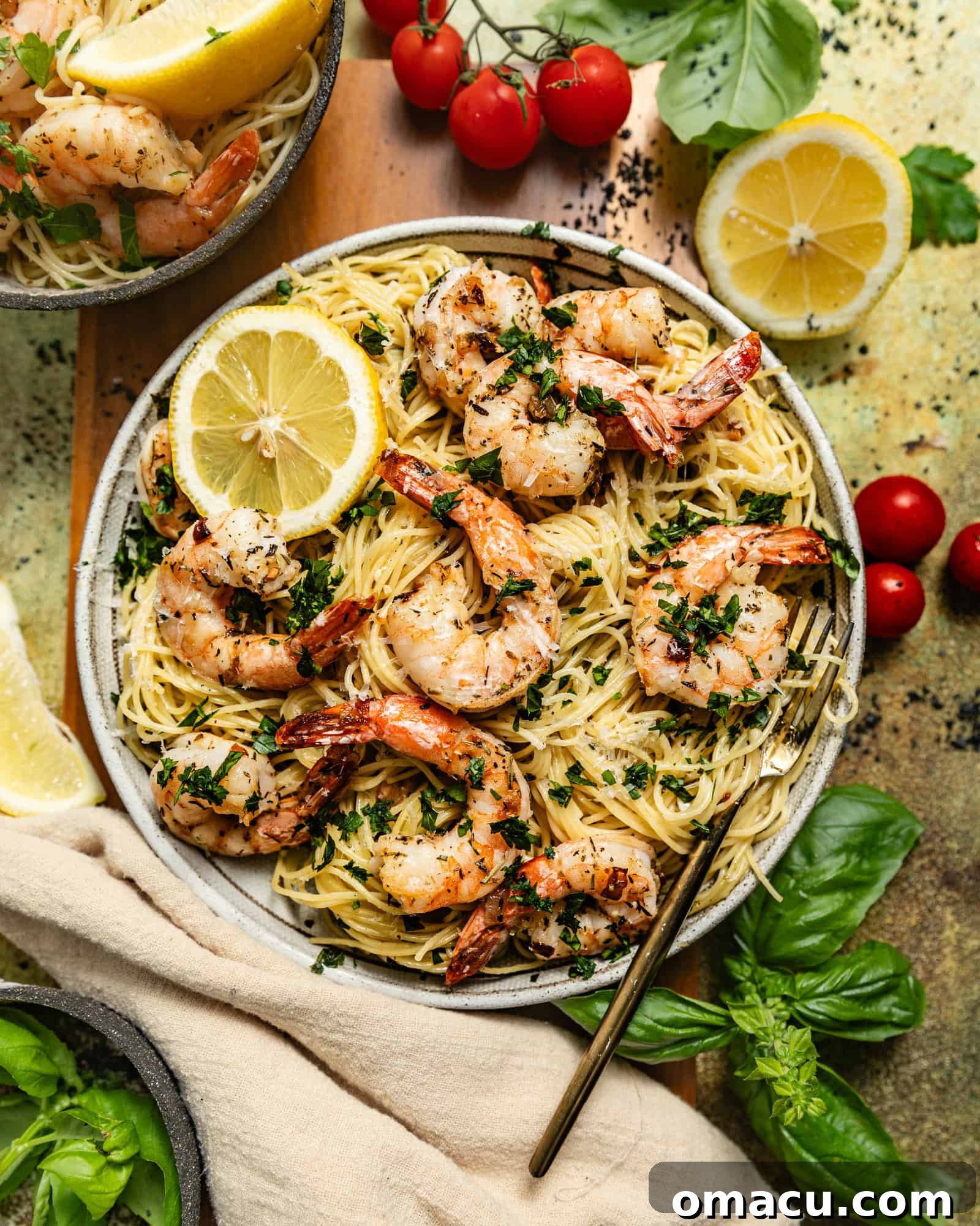 A close-up shot of perfectly cooked shrimp scampi with angel hair pasta, garnished with fresh parsley and lemon wedges.