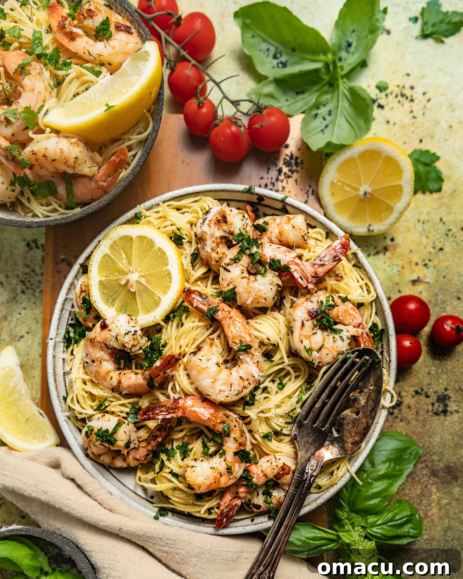 A bowl of shrimp scampi, showcasing the juicy shrimp, angel hair pasta, and a rich garlic butter sauce, with a sprinkle of fresh herbs.