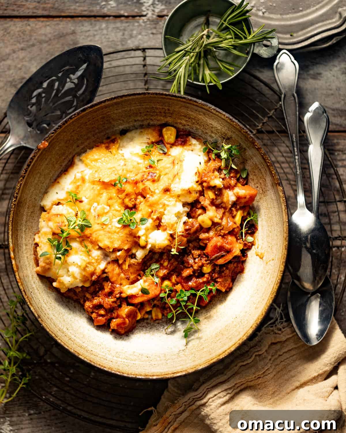 A serving of cheesy shepherd's pie in a bowl.