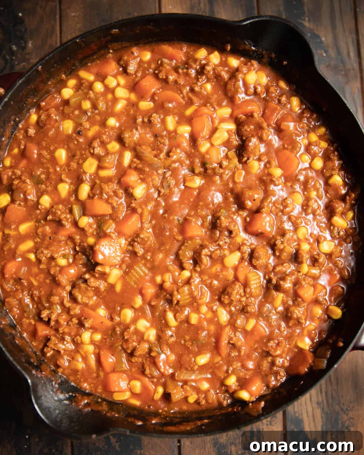 Shepherds pie filling in a cast iron skillet.