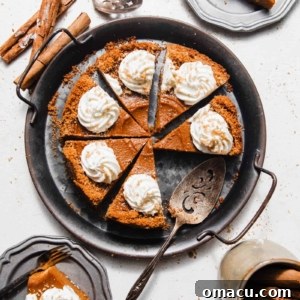 sliced sweet potato pie on a serving tray with a pie server and slices of pie on smaller plates