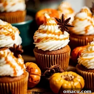 Salted caramel pumpkin cupcakes with small pumpkins around it