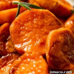 up close photo of candied yams covered in a brown sugar glaze.