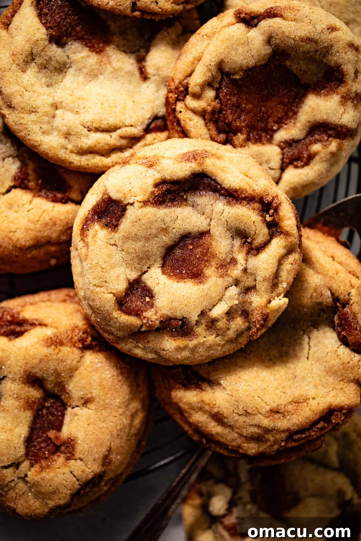 Delicious cinnamon swirl cookies arranged on a serving tray, garnished with whole cinnamon sticks