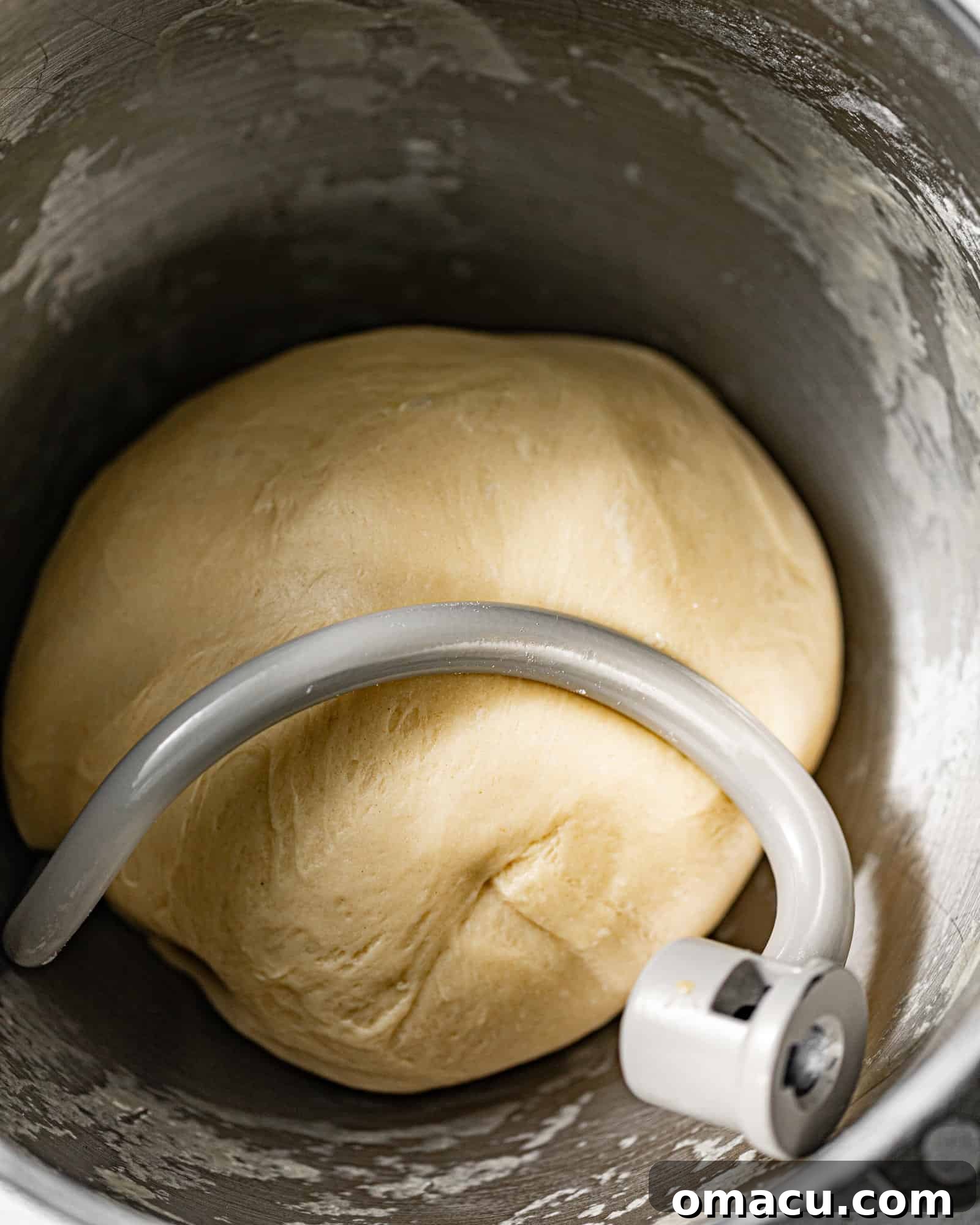 Beignet dough in a mixing bowl with a dough hook