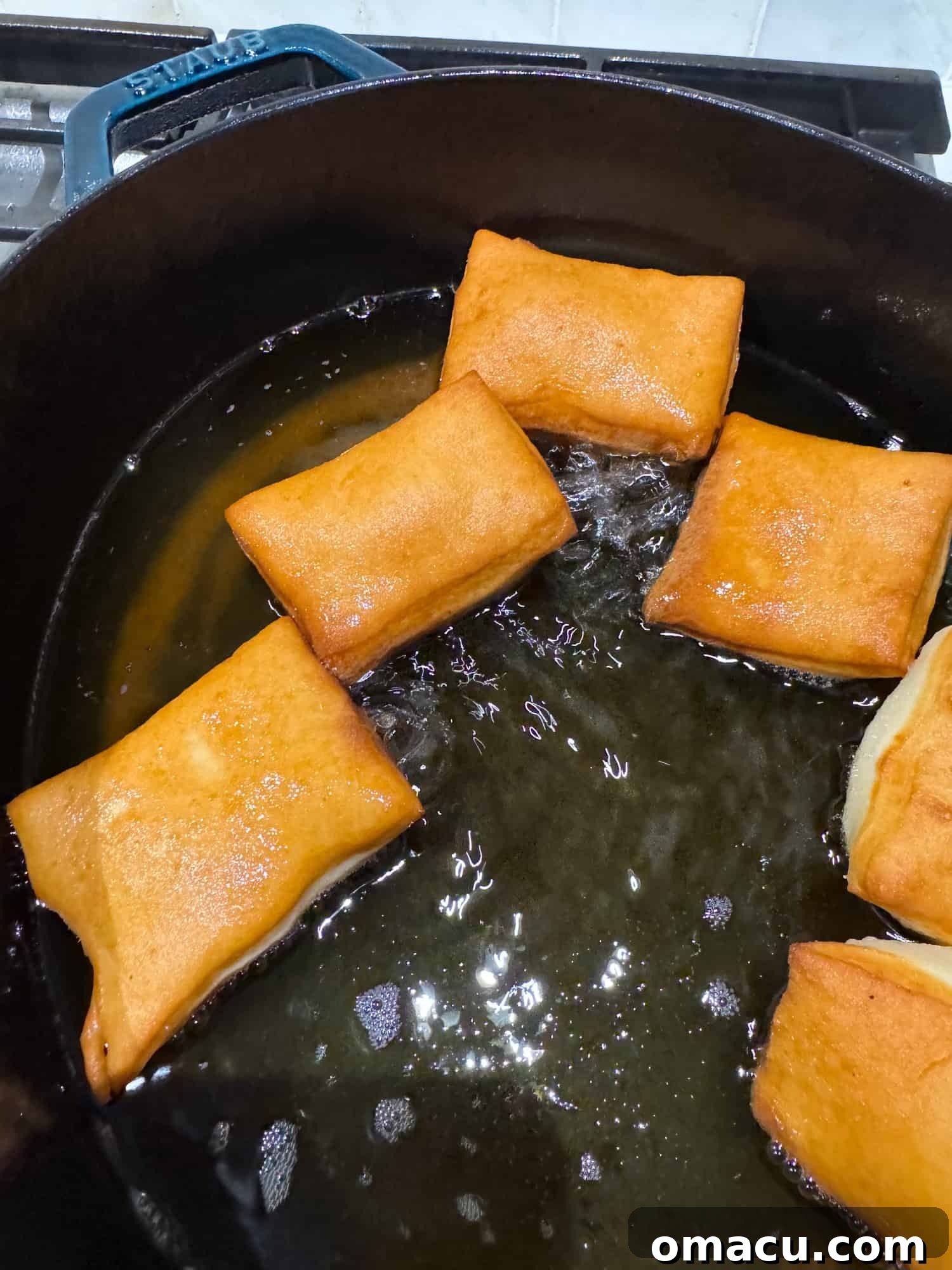 Beignets in a frying pan