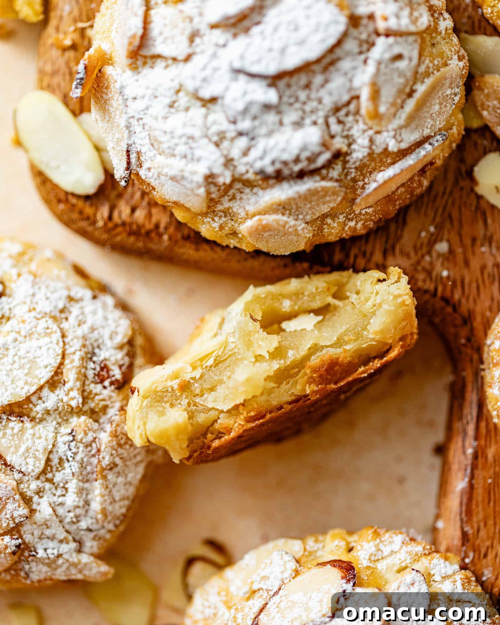 an almond croissant cookie cut in half to see the inside of the cookie.