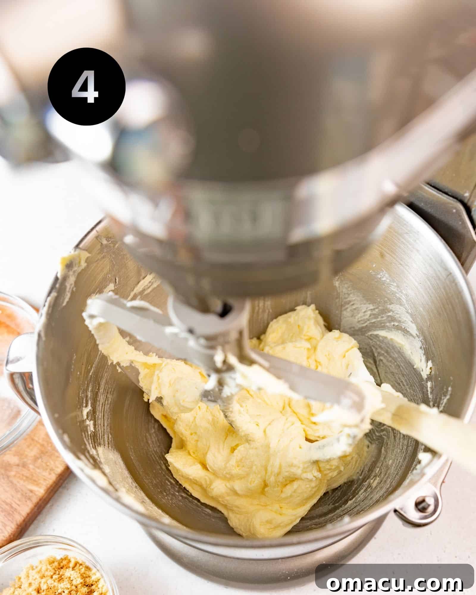 Smooth, well-mixed cake batter in a stand mixer bowl, vibrant and ready for the next step.