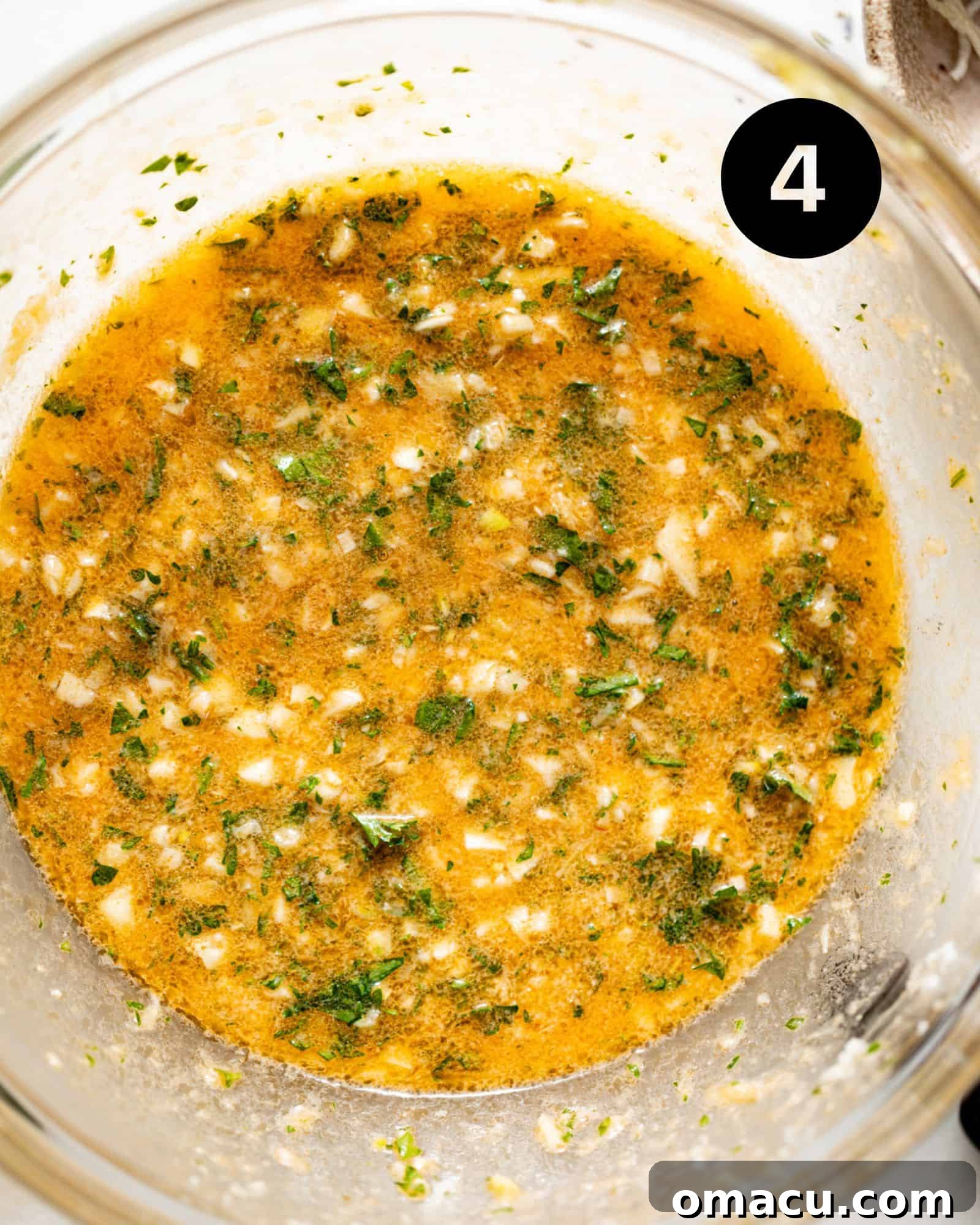 Rich garlic parmesan sauce, a creamy and aromatic mixture, ready to coat the chicken skewers.