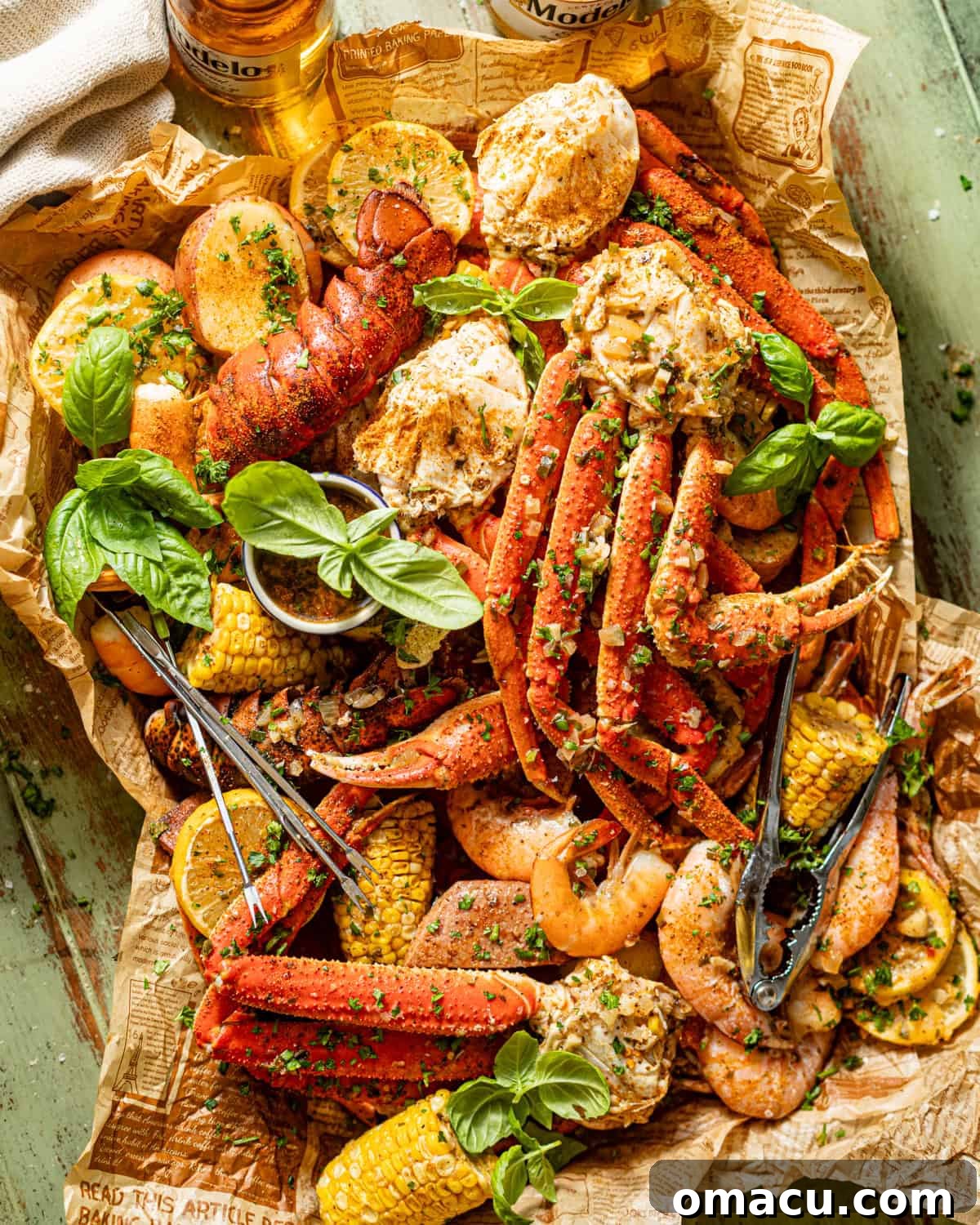 Seafood boil in a bag served on a baking sheet, glistening with garlic butter sauce, fresh herbs, and lemon slices.