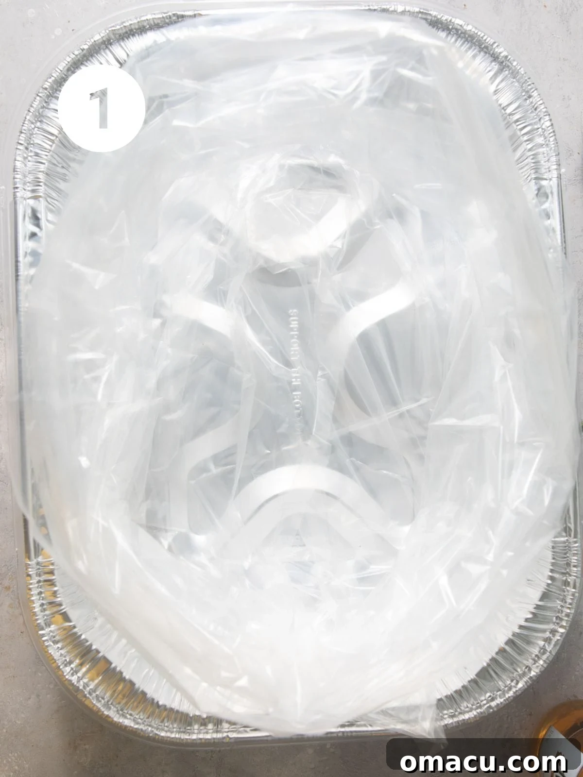 Two seafood boil bags nested in an aluminum pan, ready for ingredients.
