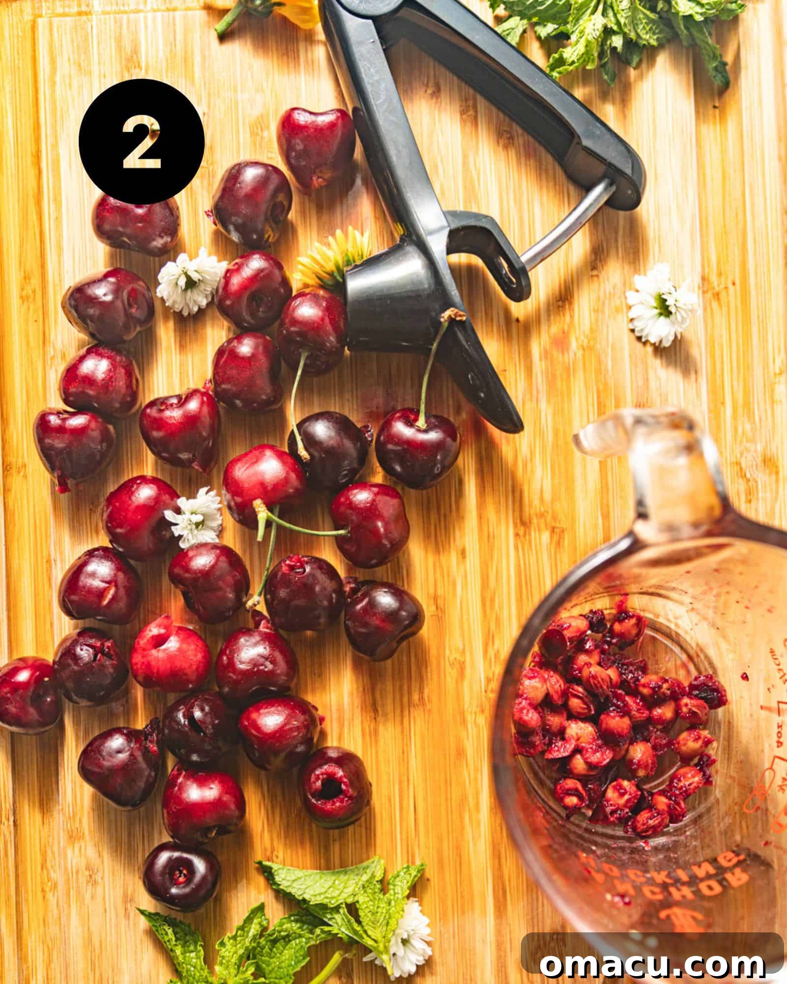 Fresh cherries on a cutting board after their pits have been removed, ready for slicing.