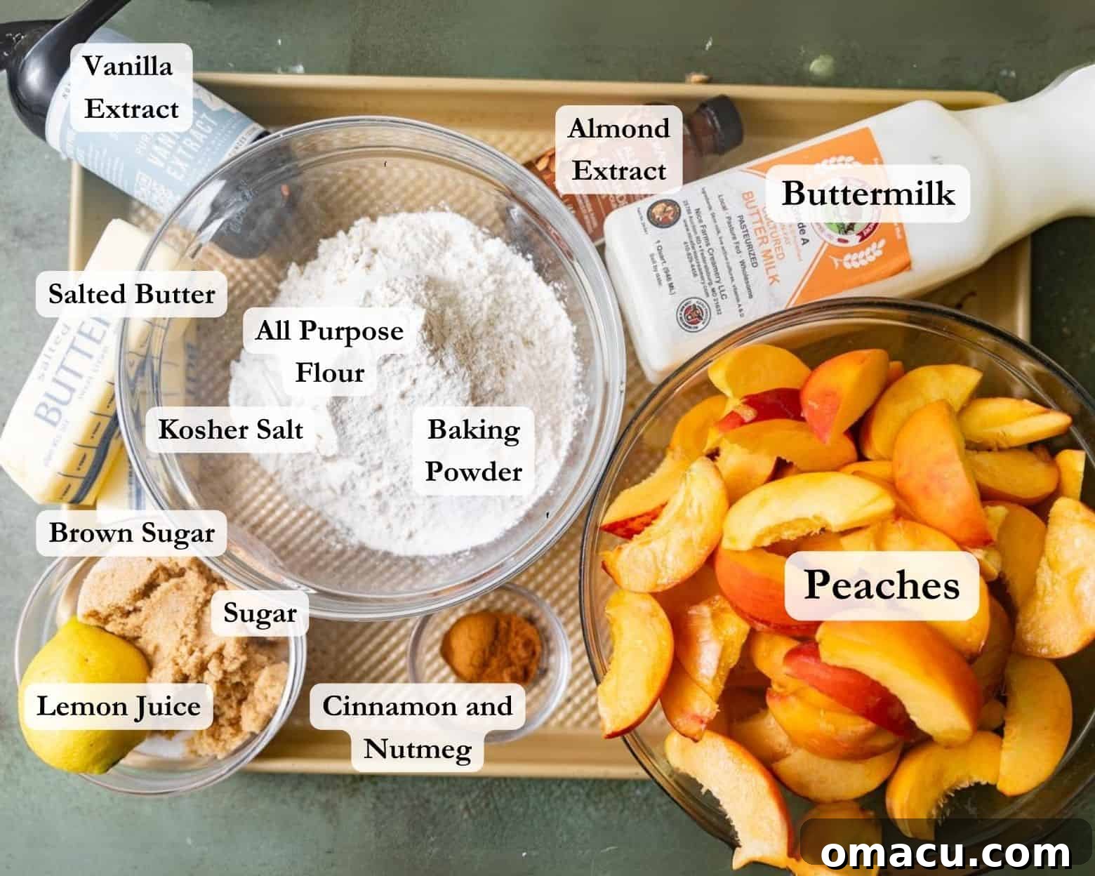 Assortment of fresh ingredients for peach cobbler: peaches, sugar, brown sugar, buttermilk, butter, flour, spices, and extracts.