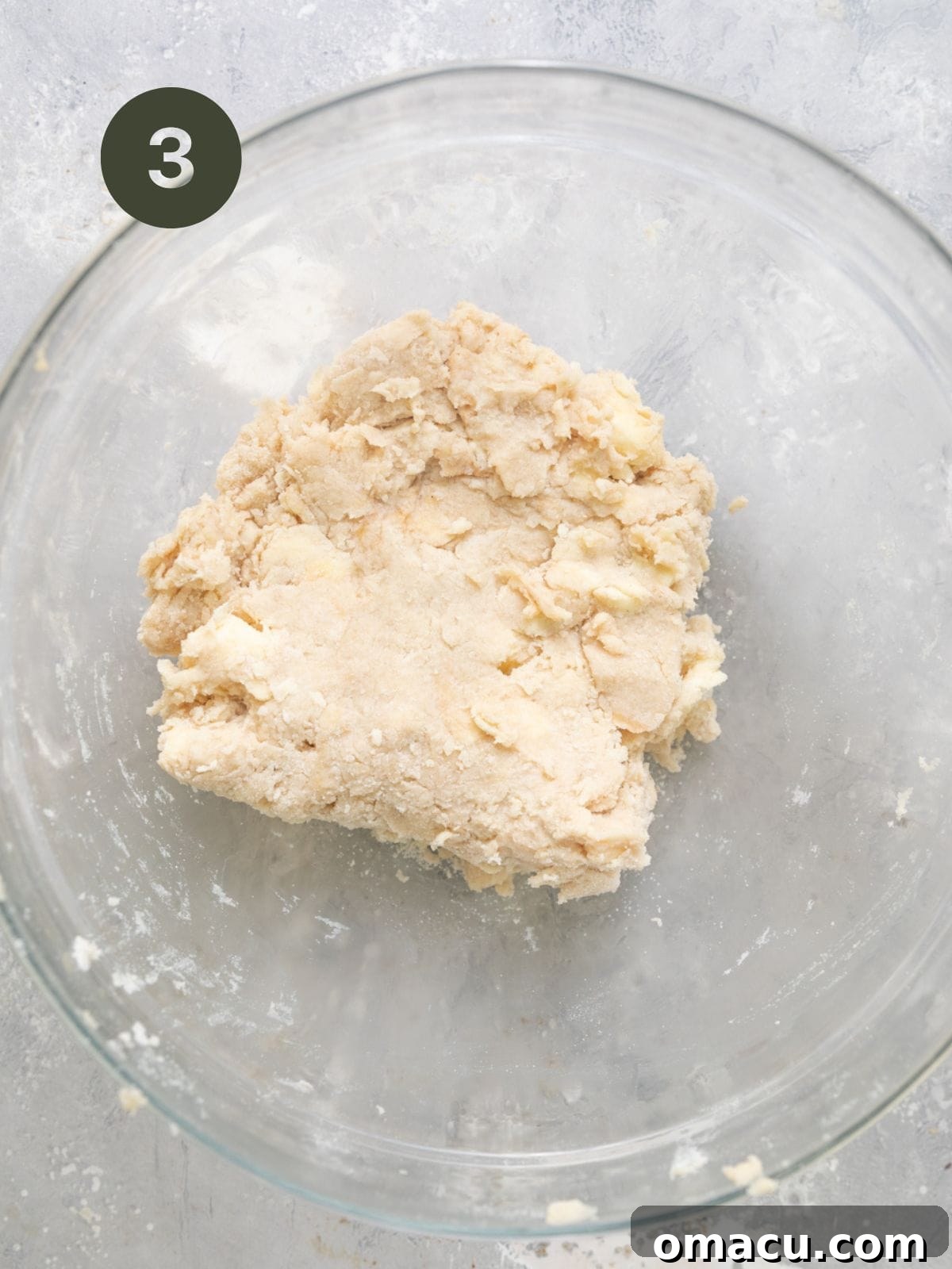 Buttermilk biscuit dough gently kneaded and gathered in a bowl, ready for chilling.