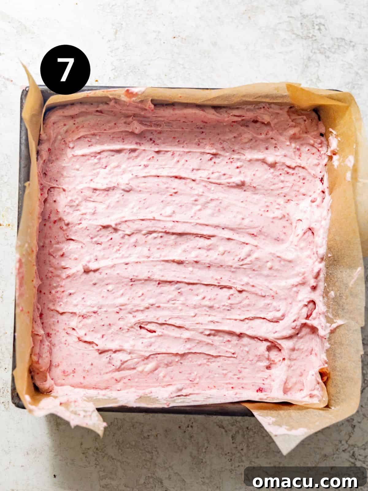 strawberry cheesecake bars assembled in a baking pan.