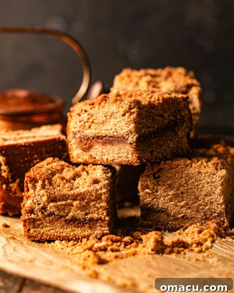 cardamom coffee cake cut into squares and stacked on top of each other.