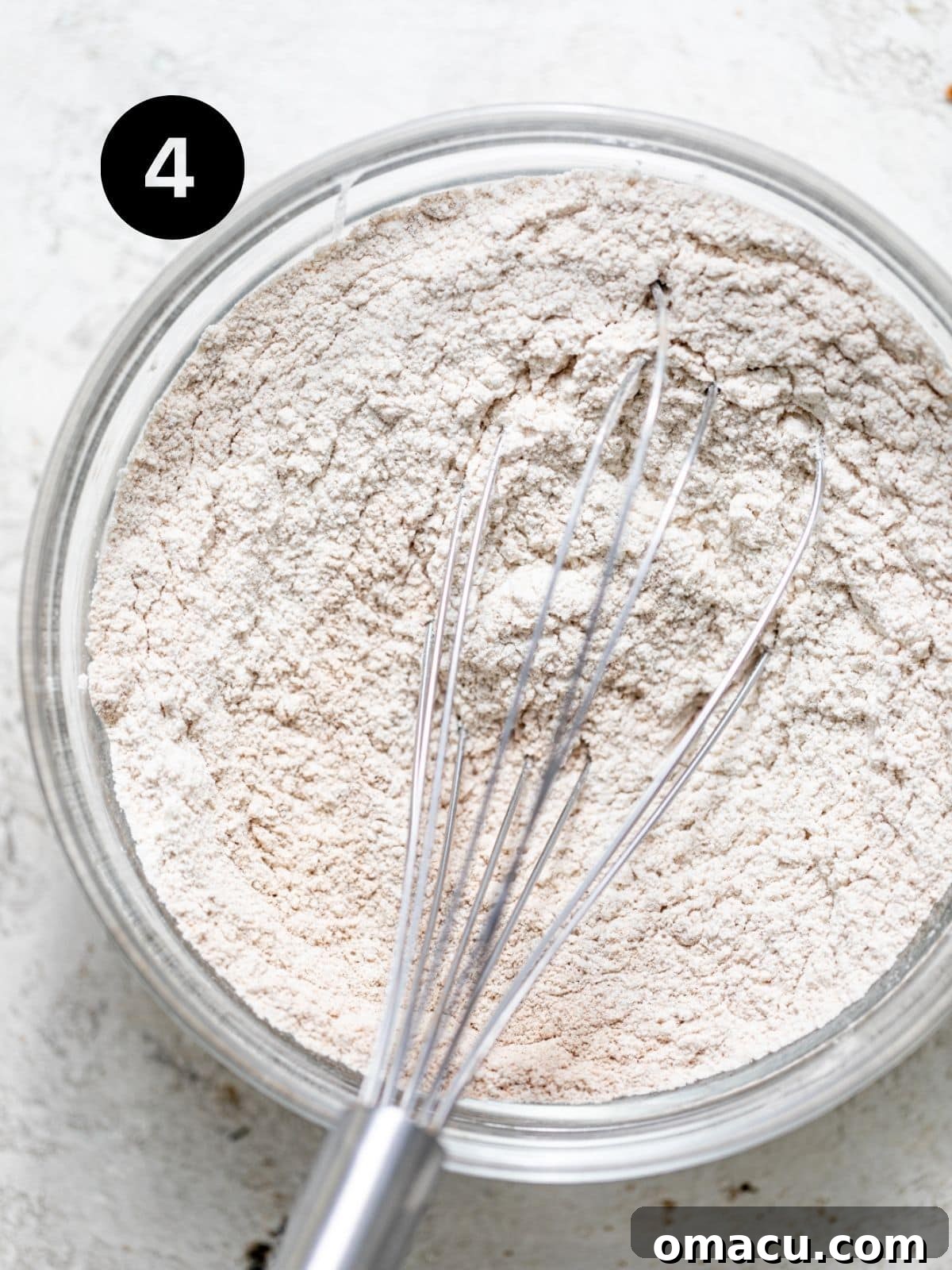 flour, baking soda, kosher salt, cinnamon, and cardamom whisked together in a bowl. 