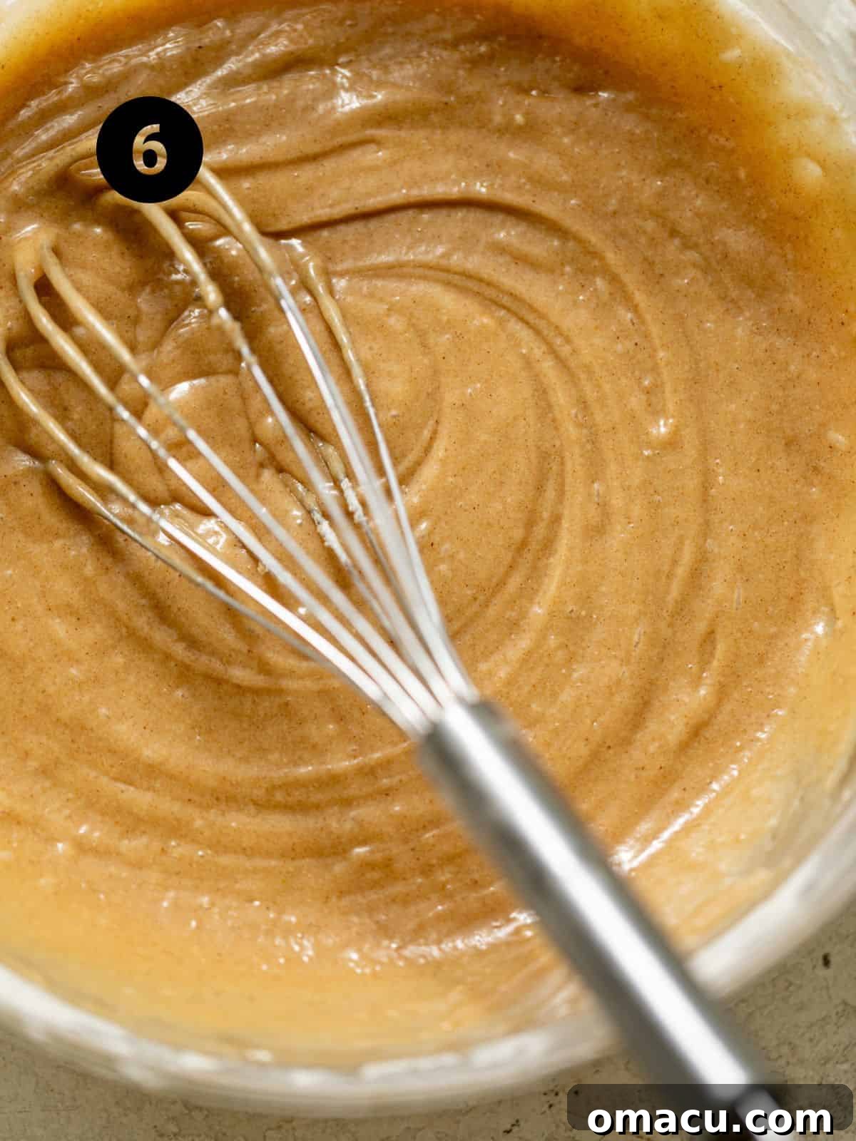 coffee cake batter in a bowl with a whisk.