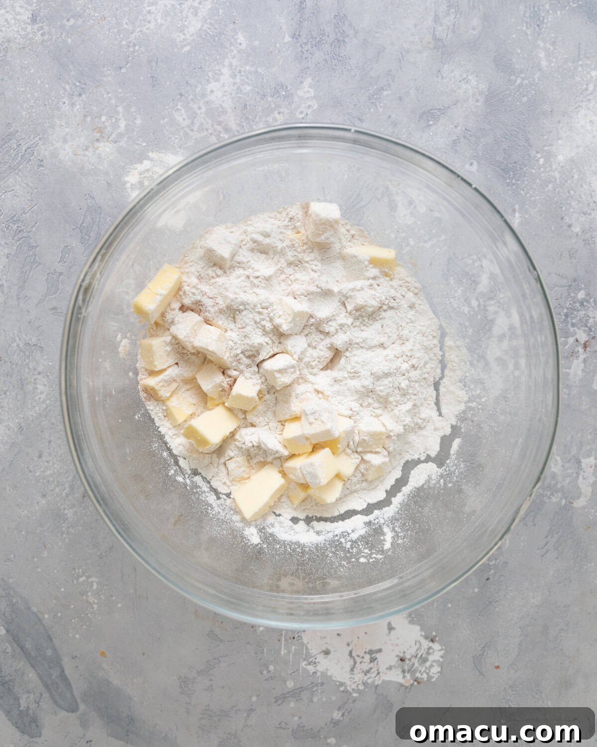 Dry and wet ingredients for shortcake crumble mixed together in a bowl, ready to be formed.