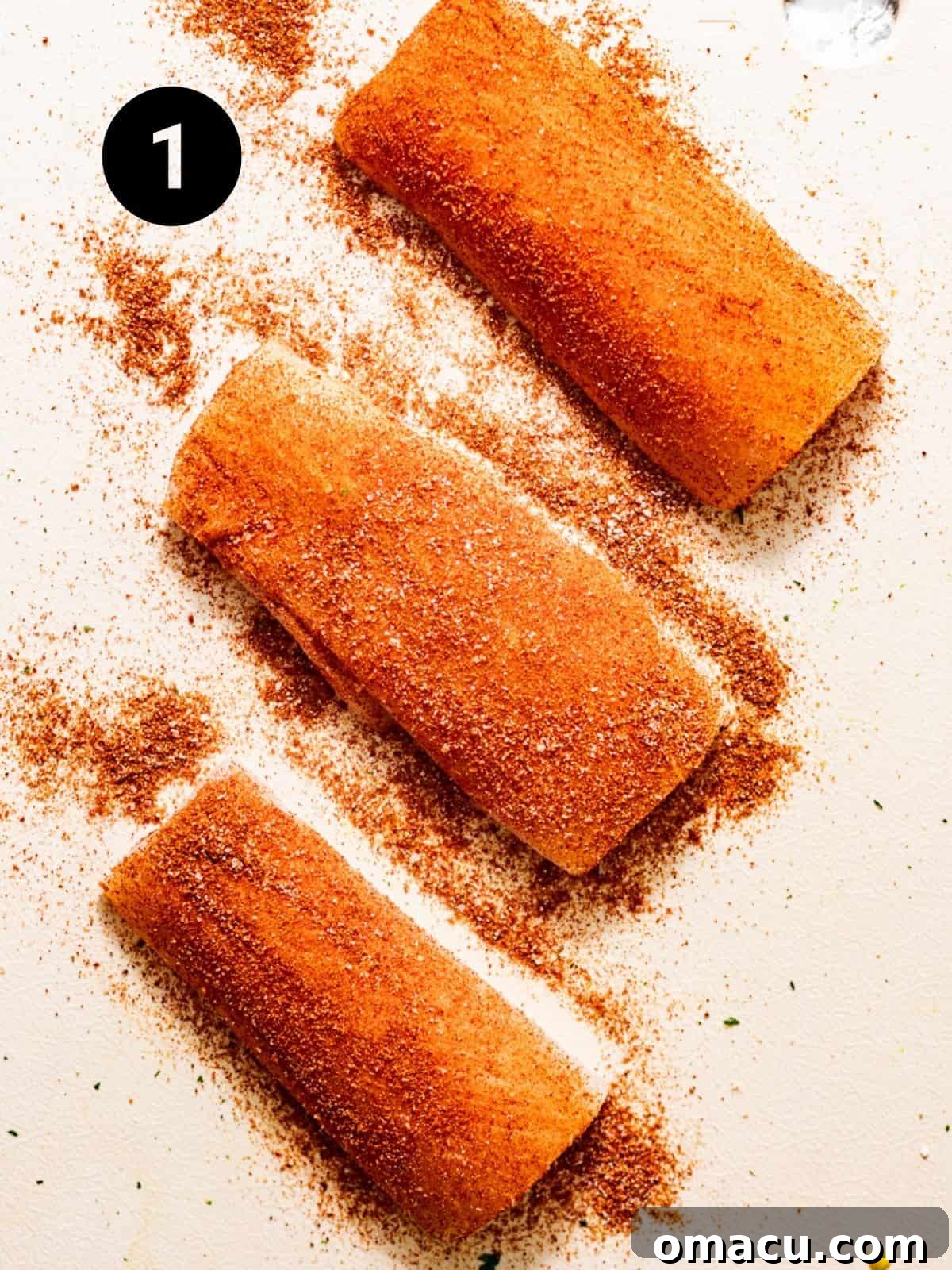 Mahi mahi fillets generously coated with a homemade blackened seasoning blend, meticulously arranged on a clean cutting board, ready for the cooking process.