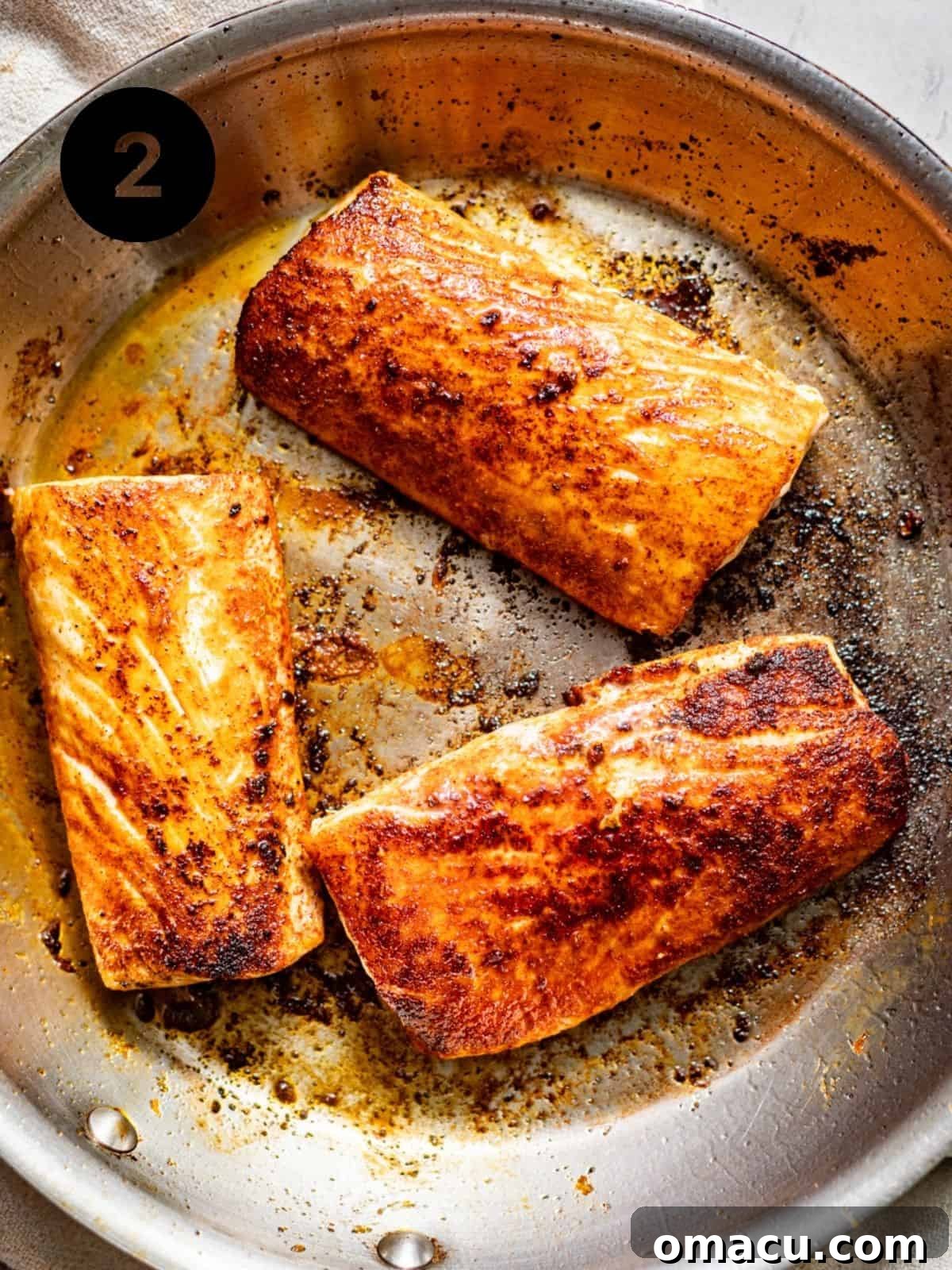 Perfectly seared mahi mahi fillets, displaying a rich, dark, and flavorful crust, sizzling in a hot nonstick skillet, ready to be removed.