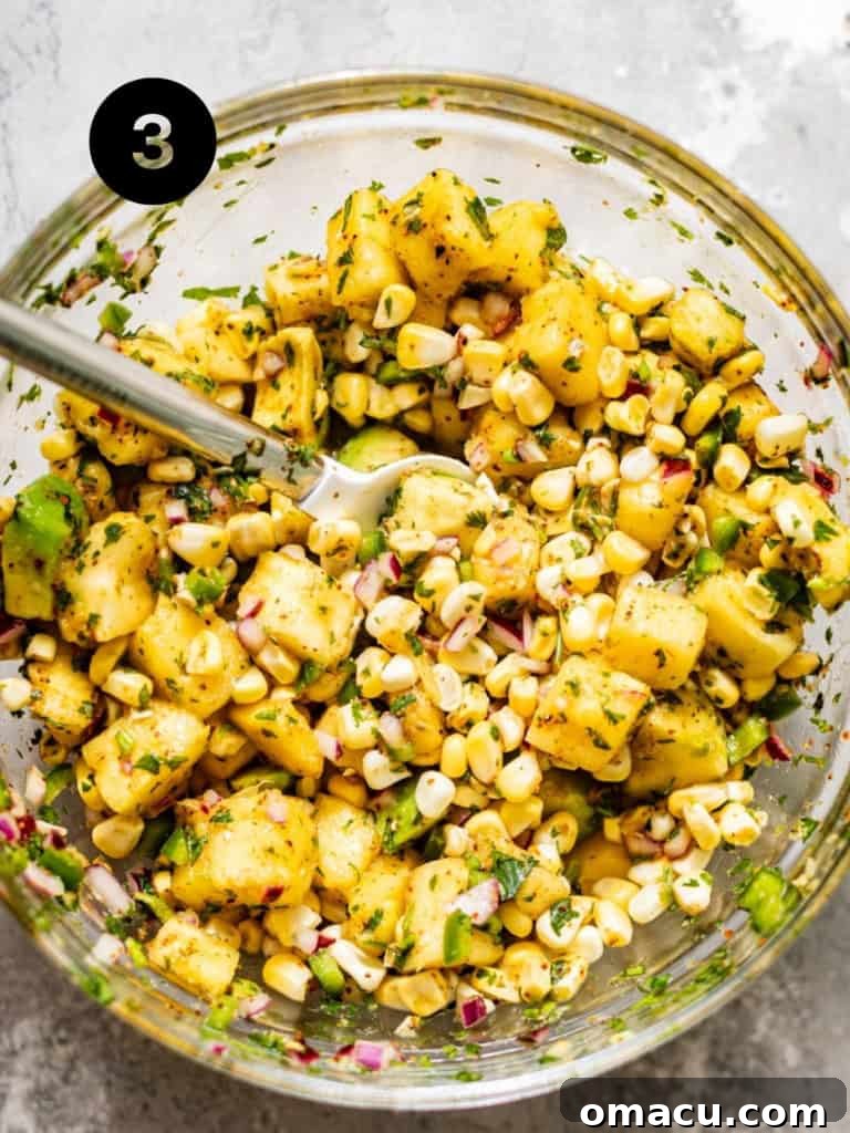 A vibrant, refreshing bowl of homemade pineapple salsa, perfectly mixed with colorful ingredients, ready to be served as a delightful topping.