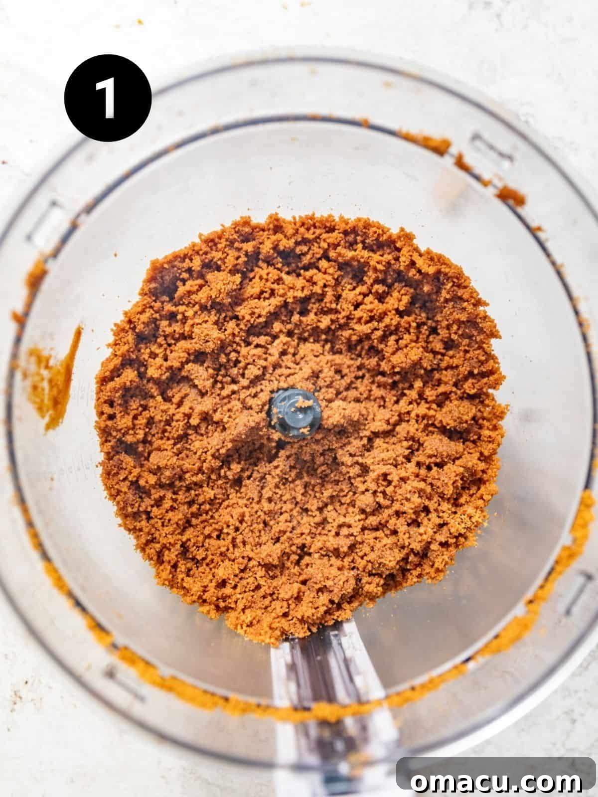 Biscoff cookies being perfectly ground into fine crumbs within a food processor, ready to form the flavorful crust for the key lime bars.