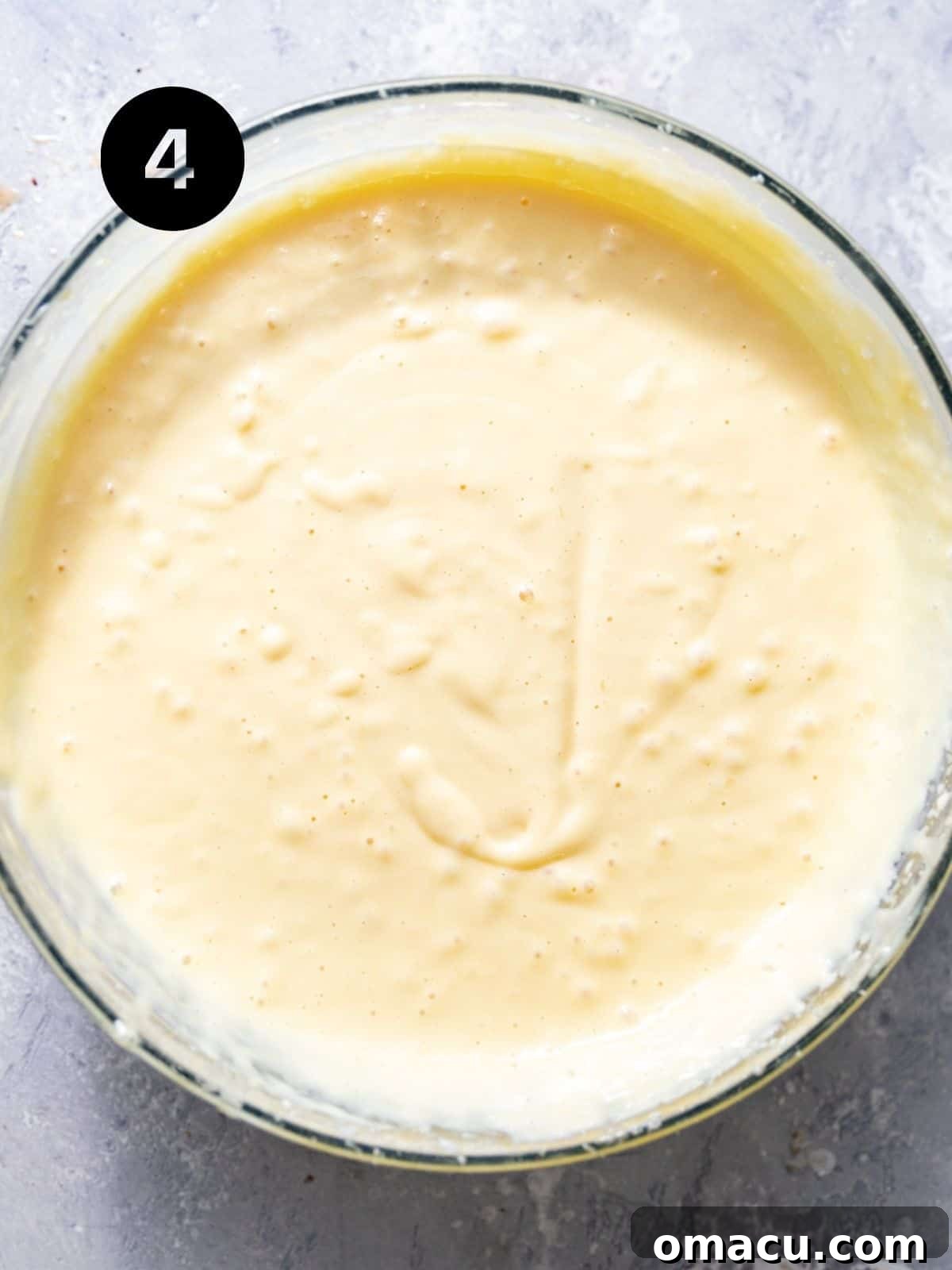 The vibrant and smooth key lime pie filling, a perfectly blended mixture of sweet, tangy, and creamy ingredients, ready for baking.