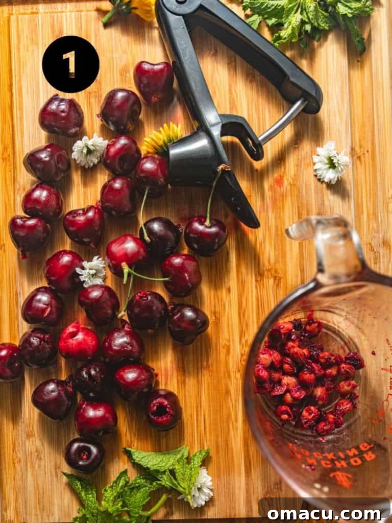 Fresh cherries arranged on a wooden cutting board, with some cherries already pitted and neatly halved, illustrating the preparation process for the fruit salad.