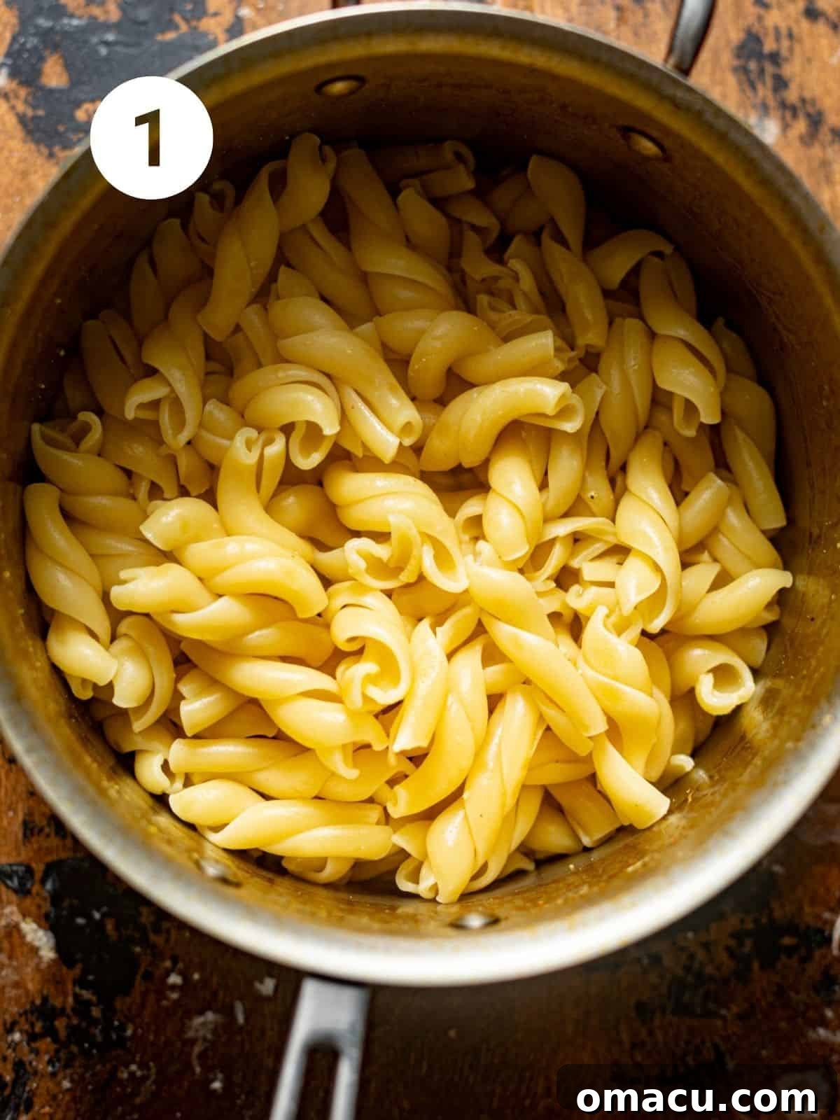 Pasta boiling in a large saucepan on a stove, with steam rising.