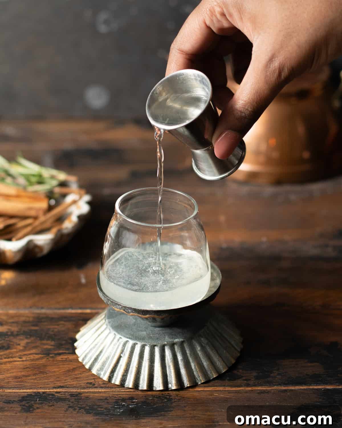 peach schnapps beings poured into a shot glass.