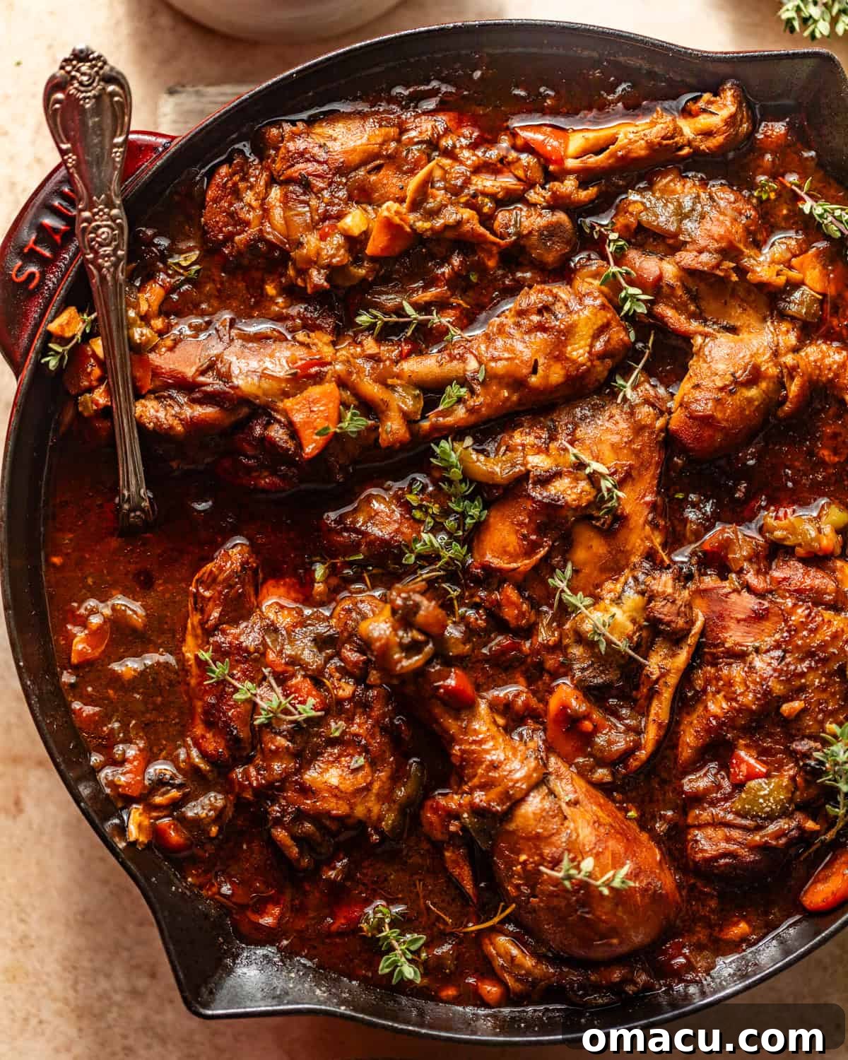 A close-up view of the finished brown stew chicken, showcasing its rich, thick gravy and tender chicken pieces, ready to be served.