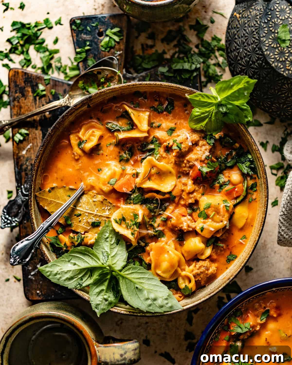 A beautifully presented bowl of creamy Tuscan tortellini soup, adorned with fresh herbs and a delicate drizzle of high-quality olive oil.