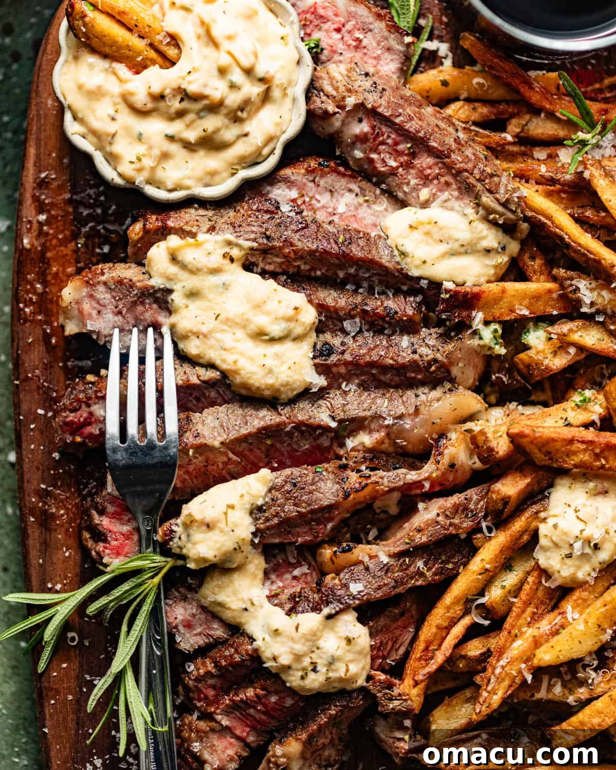 Close-up photo of a juicy ribeye steak with luscious béarnaise sauce generously drizzled on top, ready to be served.