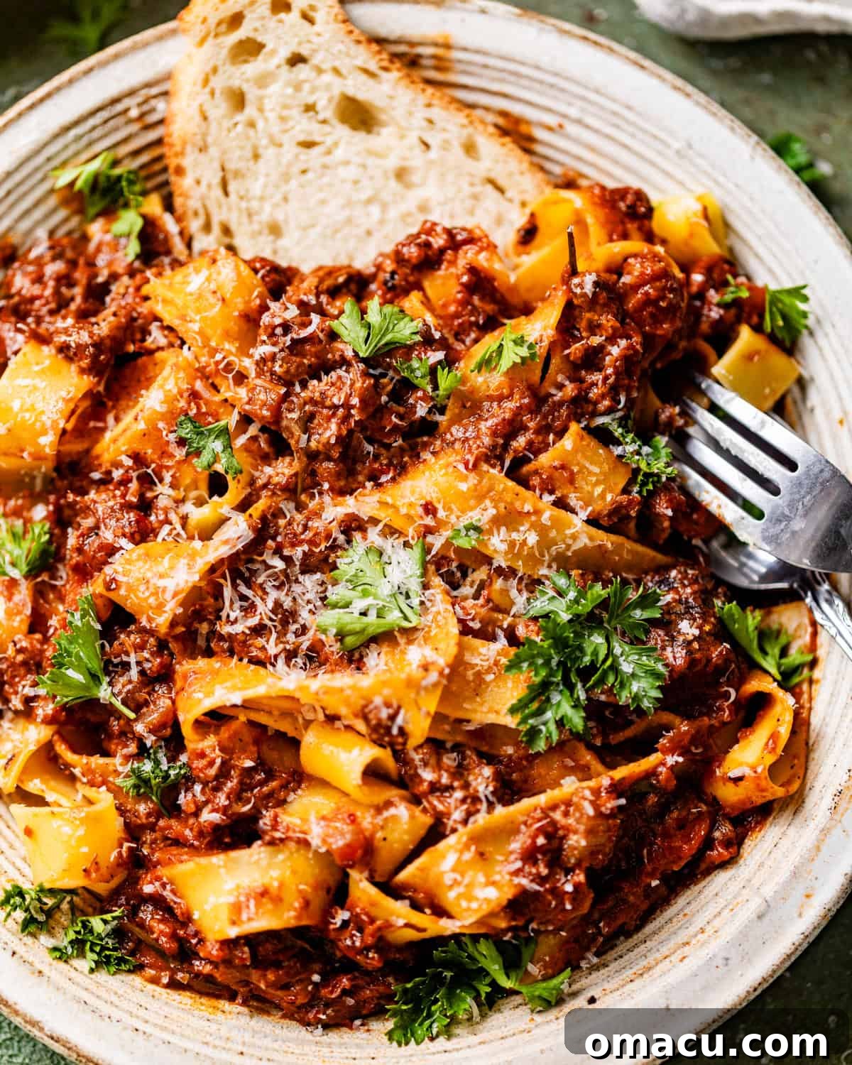 A close-up shot of rich short rib ragu served on a plate, showcasing its thick texture and tender meat.
