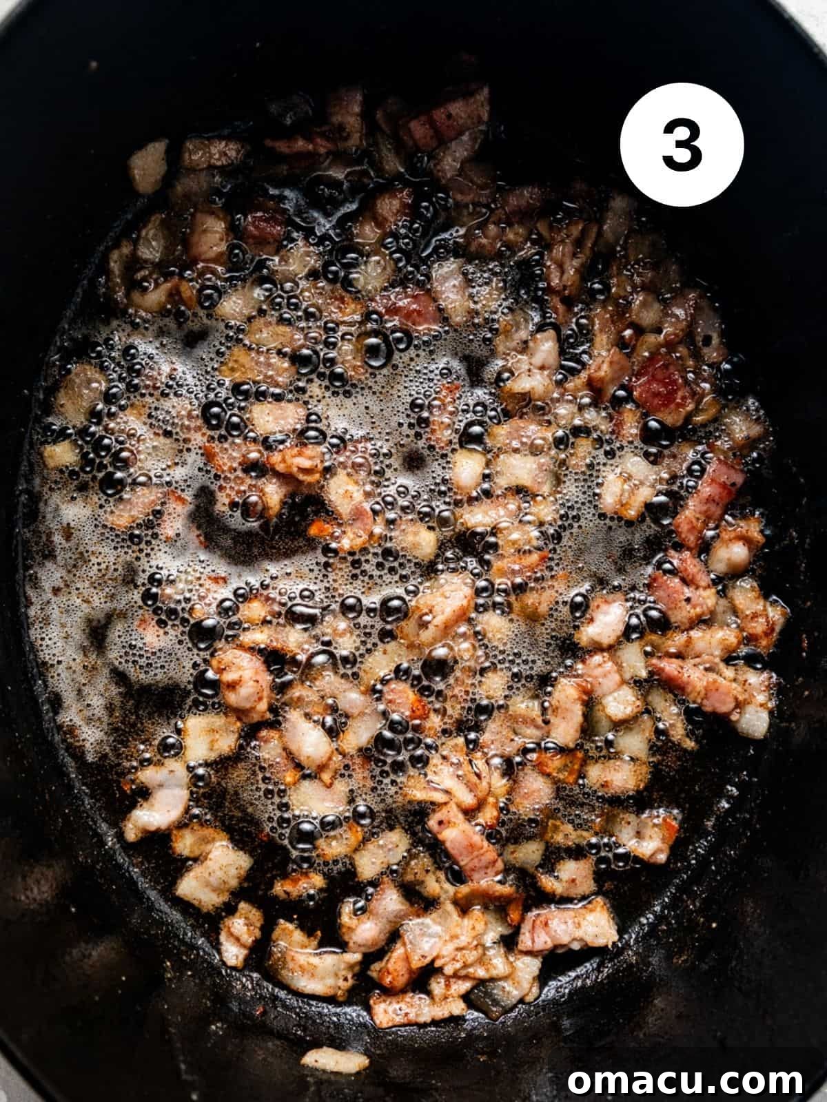 Bacon cooking and rendering fat in a large Dutch oven, preparing the base for the ragu.